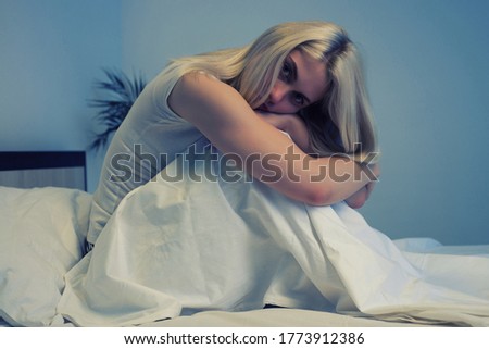 Baby sleeping on a blanket while her mother looks