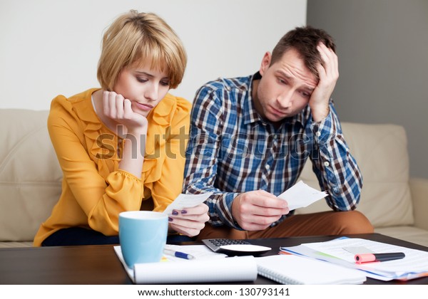 Sad Depressed Young Couple Paying Bills Stock Photo (Edit