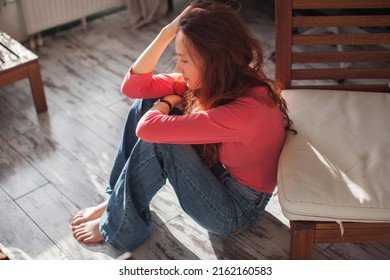 Sad depressed young woman feeling bad down on couch at home. Hopeless alone, upset teen female victim in trouble being heartbroken offended abused, having problem addiction, girl in despair concept
