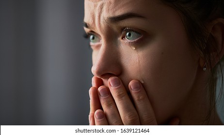Sad desperate grieving crying woman with folded hands and tears eyes during trouble, life difficulties, depression and emotional problems - Shutterstock ID 1639121464