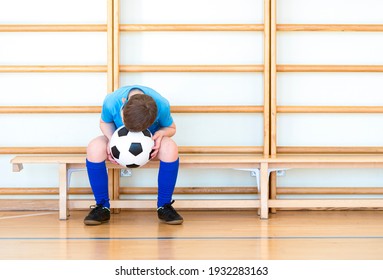 Sad Disappointed Boy With  Soccer Ball In A Physical Education Lesson. Safe Back To School During Pandemic Concept