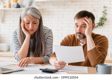 Sad Disappointed Mature Middle-aged Couple Family Wife And Husband Counting Funds, Savings, Declarations, Investments,paperwork, Financial Documents, Bankruptcy, Court Case, Bills, Pension At Home.