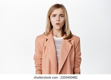 Sad And Disappointed Teen Girl, Small Kid Frowning And Sighing With Regret, Looking Miserable, Standing In Blazer Over White Background