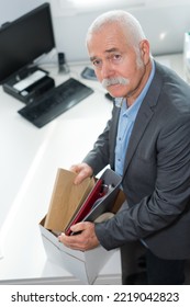 Sad Dismissed Office Worker Putting Away His Things