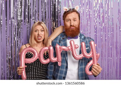 Sad dissatisfied husband and wife have spoiled party, discontent with shindig, expected more positive emotions, wear fashionable clothes, need entertainment, get together. Festive event concept - Shutterstock ID 1361560586