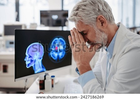 Sad doctor looks at an MRI scan, patient's bad test results, feeling helpless. Recurrence of the disease