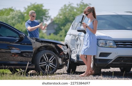 Sad drivers photographing on sellphone camera wrecked vehicles on street side for insurance service after car accident. Road safety concept - Shutterstock ID 2275384697