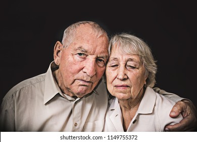 Sad Elderly Couple On A The Black Background. Coronavirus CoVid-19, Illness And Senior People Concept