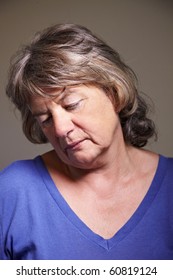 Sad Elderly Woman Looking Down With Head Tilted