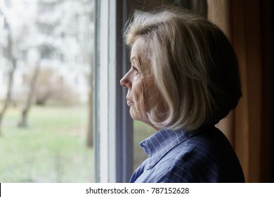 Sad Elderly Woman Looking Out The Window