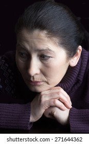 Sad Elderly Woman On A Black Background