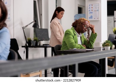 Sad Employee Having Headache At Work, Touching Forehead, Exhausted Woman In Coworking Space. Office Worker Suffering From Migraine Symptom, Frustrated Person Feeling Unwell At Workplace