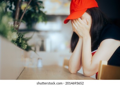 Sad And Exhausted Fast Food Worker Suffering From Burnout. Restaurant Employee Crying Having A Breakdown From Burnout And Stress At The Workplace
