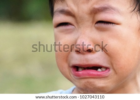Sad expression Asian boy crying 