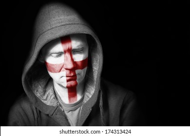 A Sad Expression On The Face Of A Football Fan With Their Face Painted With The English Flag.