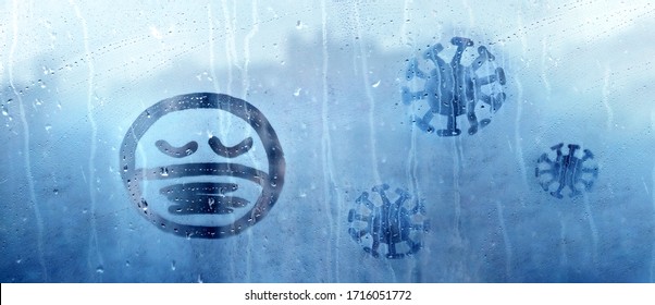 Sad Face With Closed Eyes In Protective Medical Mask And Three Coronavirus Molecules Figure Is Painted On Wet Blue Window With Raindrops Concept Photo Self-isolation, Banner, Covid - 19