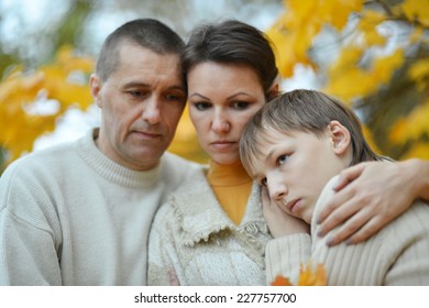 Sad Family Of Three On The Nature