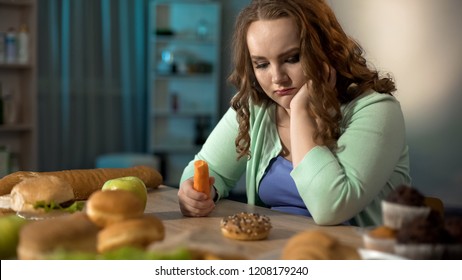 Sad Fat Girl Eating Carrot And Dreaming About Sweet Donut, Healthy Dieting