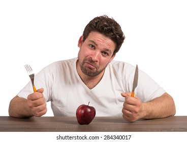 Sad fat man eating only an apple