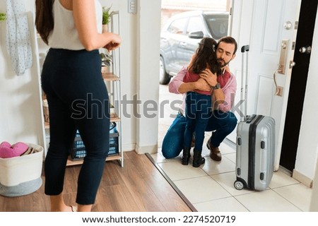 Sad father with a torn apart family hugging his little daughter and saying goodbye after leaving home because of divorce