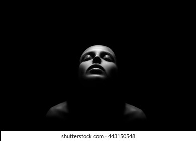 sad female head with closed eyes in dark