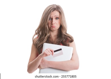 Sad Female Holding Empty Credit Or Debit Card And A Laptop In Her Arms