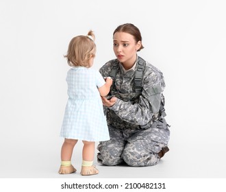 Sad Female Soldier With Her Baby Girl On White Background