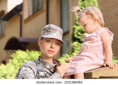 Sad Female Soldier With Her Baby Girl Outdoors