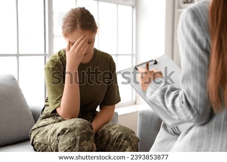 Sad female soldier in psychologist's office
