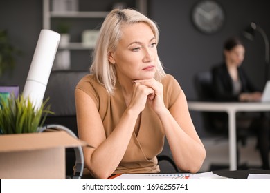 Sad Fired Mature Woman With Personal Stuff In Office