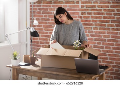 Sad Fired Young Employee Packing A Box To Leave The Office