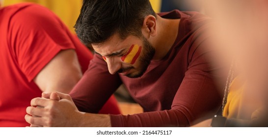 Sad Football Fan Sitting At Football Stadium, Spanish National Team In Live Soccer Match.