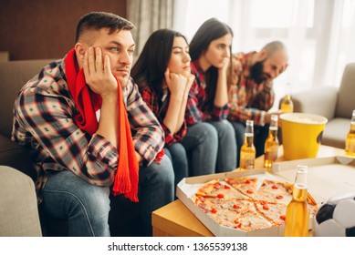 Sad Friends Watching TV At The Boring House Party