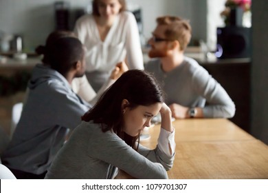 Sad Frustrated Young Girl Feeling Lonely Sitting Alone At Cafe Table, Upset Social Outcast Or Loner Teenager Suffering From Low Self Esteem Complex, Unfair Attitude Or Discrimination Among Friends