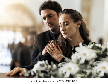 Sad, funeral and flowers with couple and coffin in church for death, respect and mourning. Grief, goodbye and empathy with man and woman loss at casket with depression, remember and farewell memorial - Shutterstock ID 2225084107