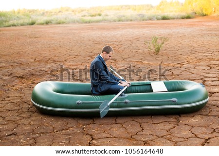 sad funny Business man stop on crack soil hot land desert boat businessman rock look bright future symbol crisis stagnation losses braking difficulties environmental disaster water scarcity drought