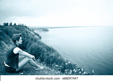 Sad Girl Alone Sits On The Beach And Misses