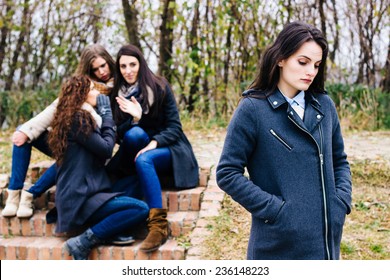 Sad Girl With Friends Gossiping In Background,  Behind Her Back