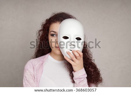 sad girl hiding behind mask