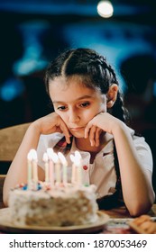 Sad Girl Looking At Her Birthday Candles Or Making Her Birthday Wish