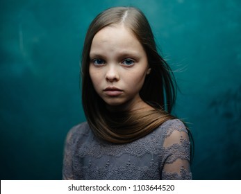 Sad Girl On Dark Green Background Studio Emotions