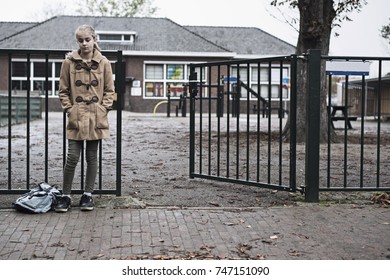 Sad Girl At School Gate Entrance Waiting Alone