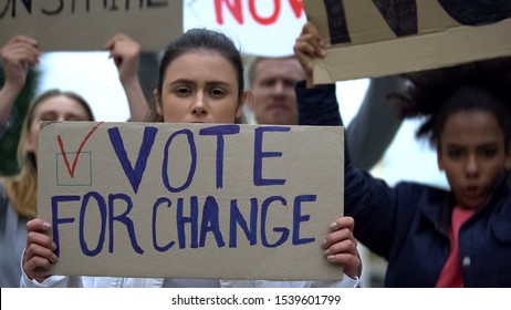 Sad Girl Showing Slogan Vote For Change, Presidential Campaign Rally, Democracy