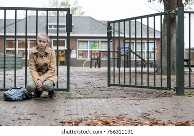 Sad Girl Sitting Alone At School Gate