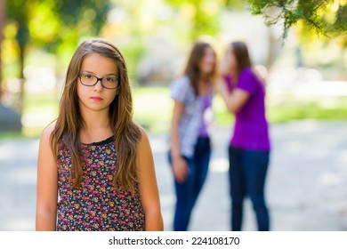 Sad Girl Standing In Front Of Her Evil Girlfriends