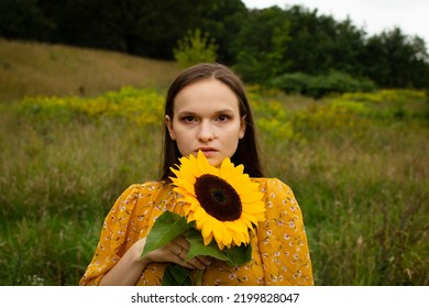 Sad Girl Standing With Sunflower