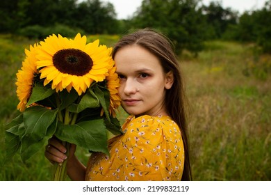 Sad Girl Standing With Sunflower