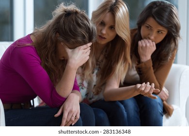 Sad girl and supporting friends trying to solve a problem