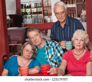 Sad Group Of Four Senior Citizens In Cafe