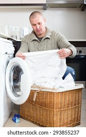 Sad Guy  Doing Laundry With Washing Machine At Home